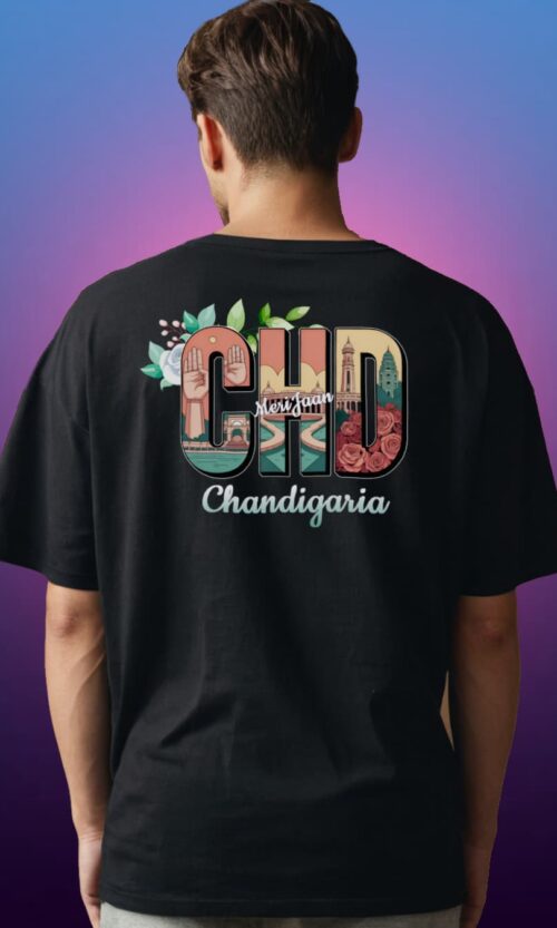 Back view of a man wearing a black CHD Chandigarh Oversized T-Shirt with city vibe design in bold letters, featuring iconic Chandigarh landmarks. Made with 210 GSM French Terry fabric.